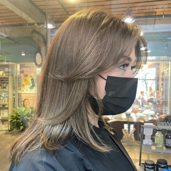 Brunette Spring Color Curtain Bangs - A woman wearing black mask