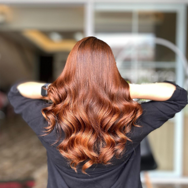 Caramel Hair Balayage for Long Hair - A woman wearing a 3/4 top