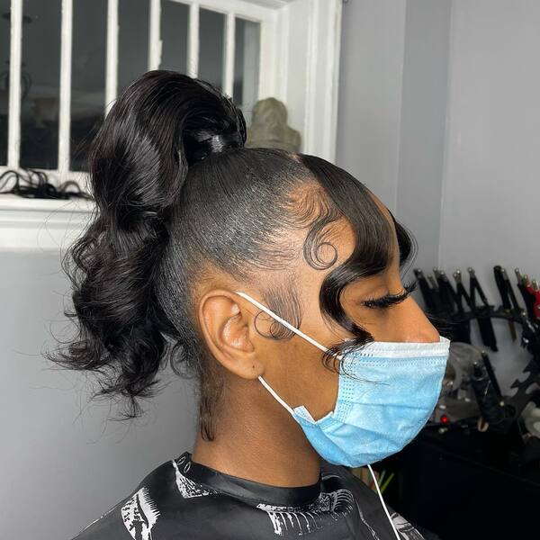 Classy Dimensional Curl Swoop Ponytail - A woman wearing a blue mask