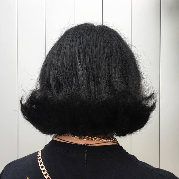 Classy Flippy Bob Hair - a woman wearing a chain necklace and a black shirt