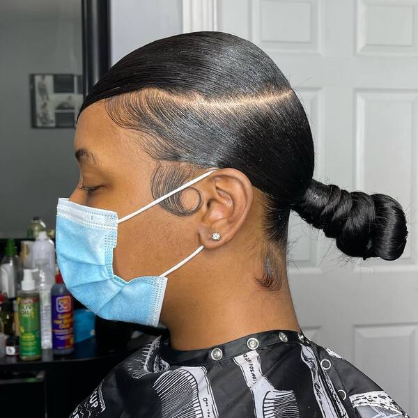 Clean Low Pony Tail - A woman wearing a blue mask