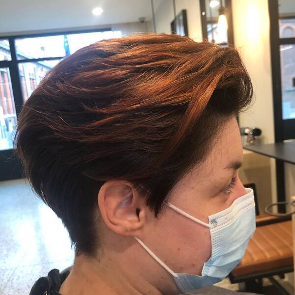 Cool Copper Brown Pixie Hair - A woman wearing a surgical mask