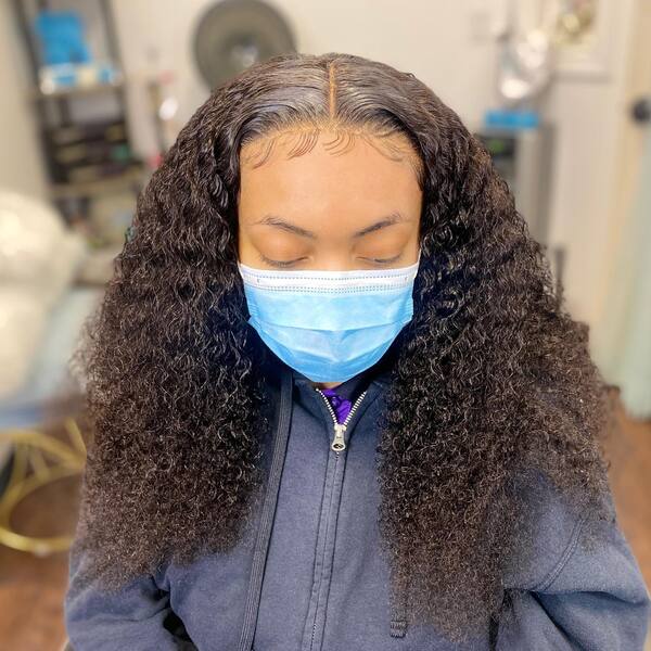 Corkscrew Curl  - A woman with blue surgical face mask wearing a blue jacket