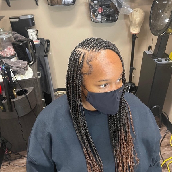 Crochet Hairstyle - A woman wearing a black longsleeve and a black facemask