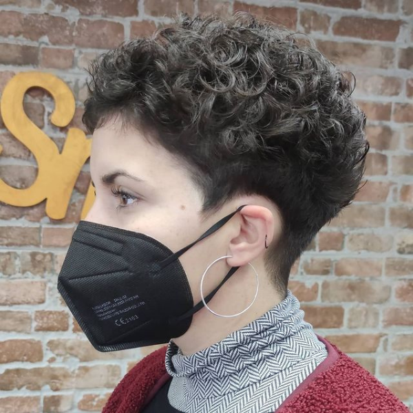 Curly Pixie Hairstyle - A woman wearing a black mask