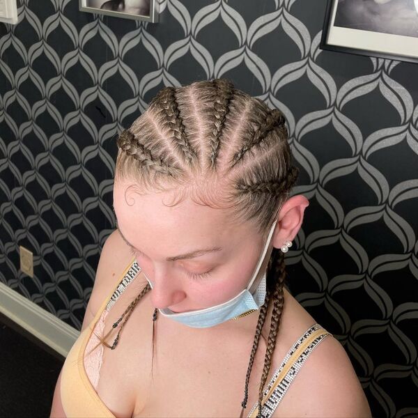 Curved Cornrows Braids - A woman wearing a spaghetti strap yellow blouse and a face mask
