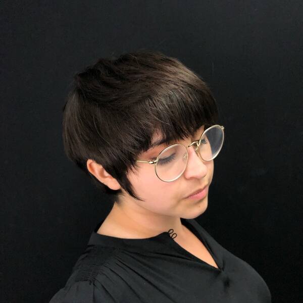 Cute Pixie Cut for Semi Round Face - A woman wearing a black blouse