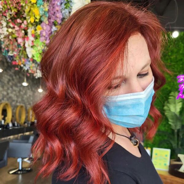 Dark Auburn with Red Lowlights Hair - a woman wearing a black shirt and a facemask