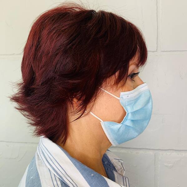 Dark Red Pixie Hair for Medium Length - A woman wearing a blue mask