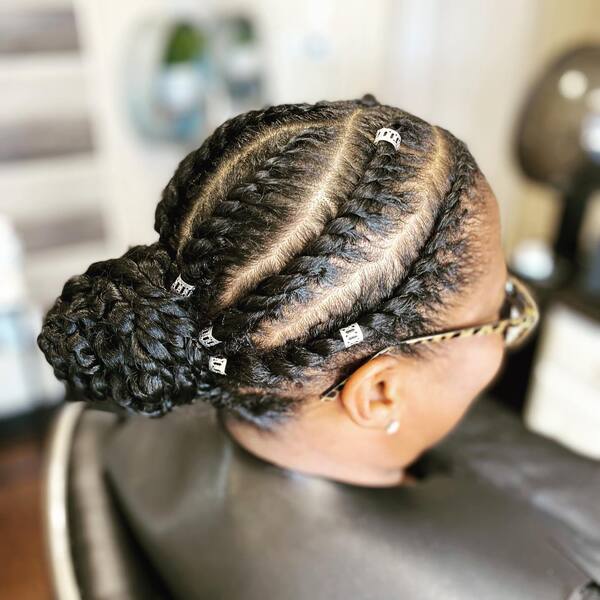 Flat Twist Bun with Decor - A woman with eyeglasses wearing a black cape