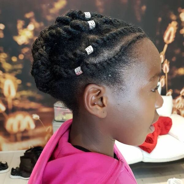 Flat Twist Cornrows - A woman with hair decor wearing a pink jacket