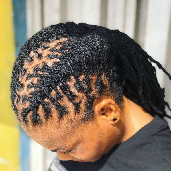 Flat Twisted Dreads - a woman wearing a black top
