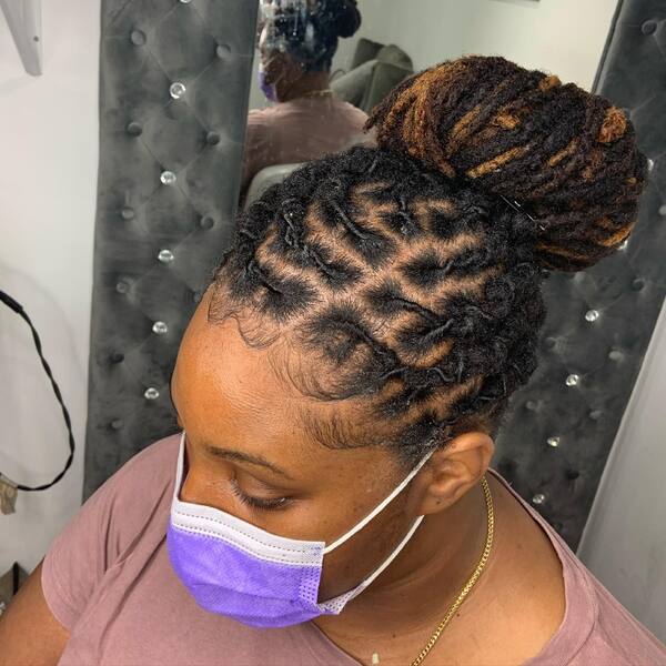 Half Up Twisted Braided Locs - A woman wearing a violet mask