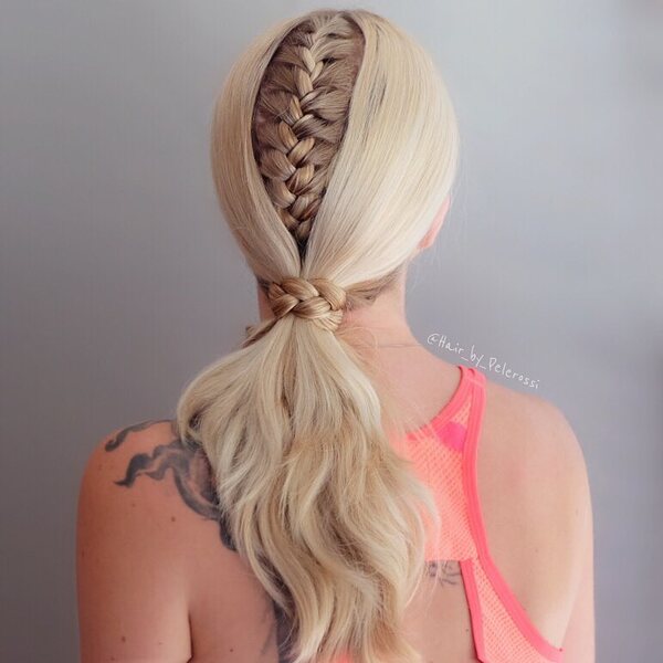 Hidden Ponytail Braid - A woman with a tattoo wearing a pink sports bra