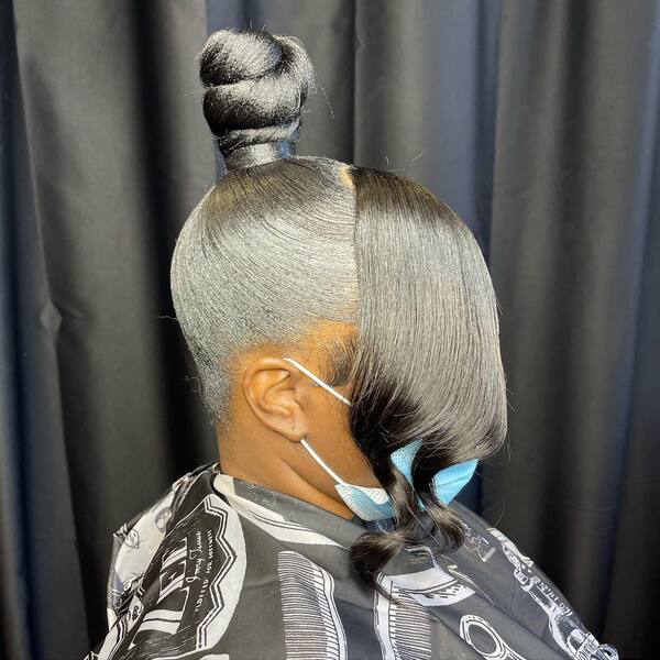A woman with her high knot bun pony hair