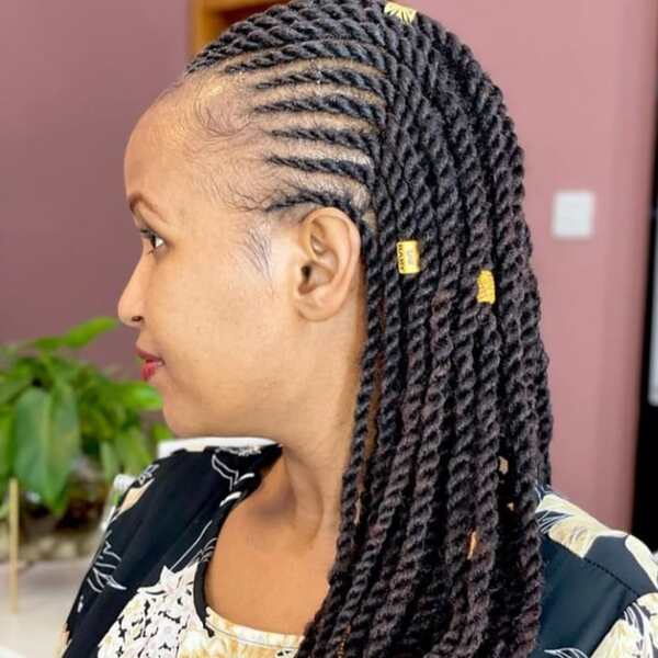 Knotless Twist - A woman with hair decor wearing a floral blouse