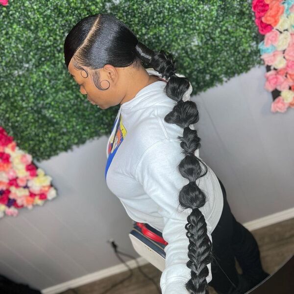 Long Sleek Bubbles Braided Ponytail - A woman wearing a white printed hooded jacket