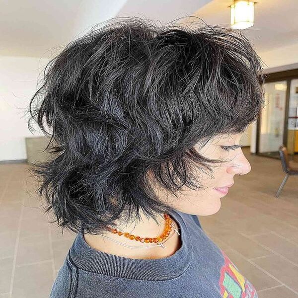 Modern Wavy Shag for Neck-Length Hair - A woman in her dark grey printed shirt