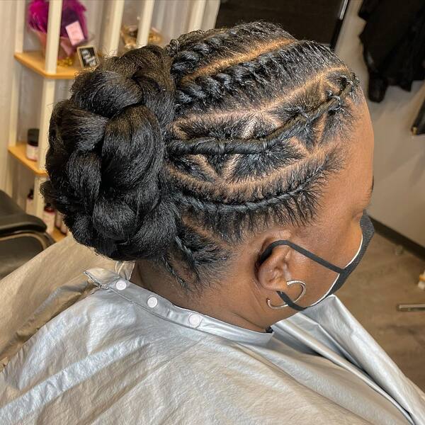 Natural Bun with Flat Twist Up Do - A woman wearing a black mask
