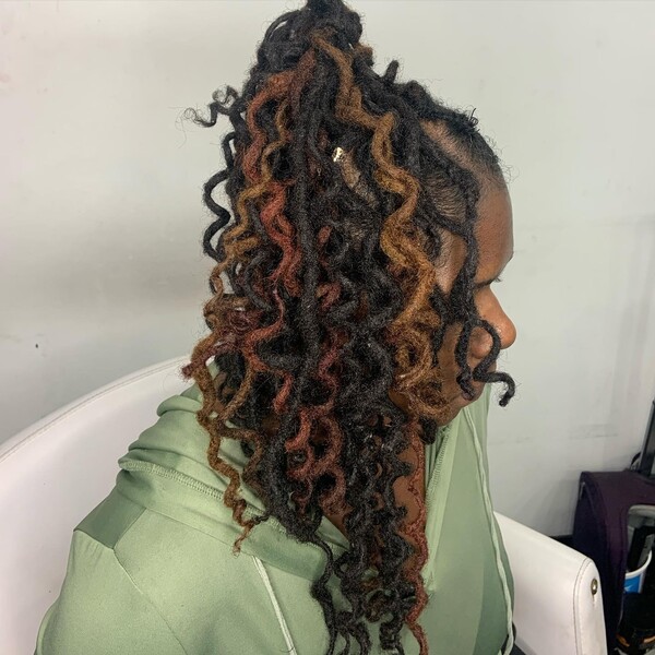 Natural Curly Dreadlocks Hair - A woman wearing a green jacker