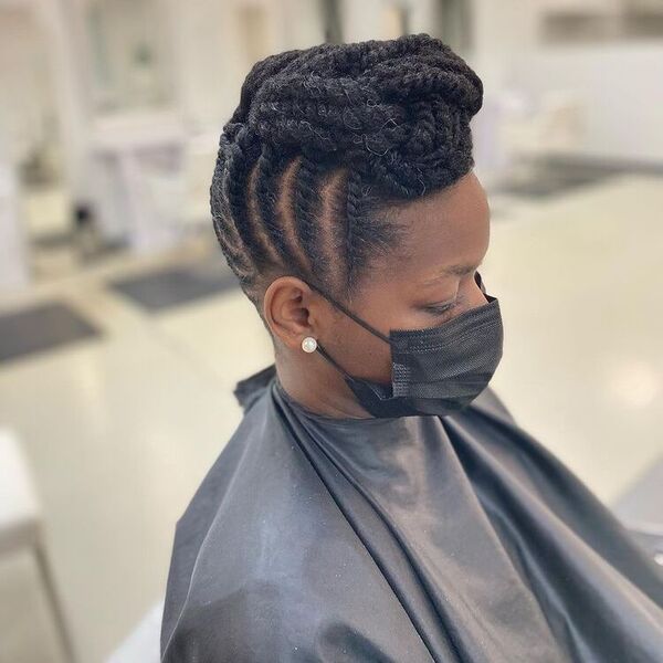 Natural Updo Twisted - A woman wearing a black cape a black facemask