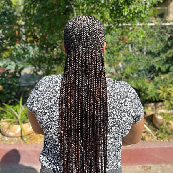 Neat Cornrows Braid - A woman wearing a color gray blouse with doodle art design