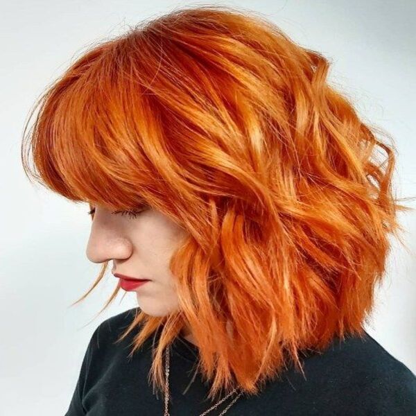Orange Shag Hair for Medium Length - A woman in her black sweater