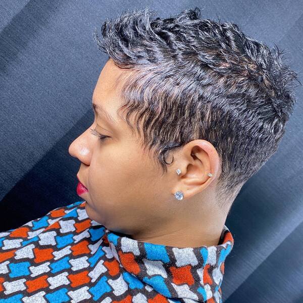 Pixie Cut for Black Women - A woman wearing earrings