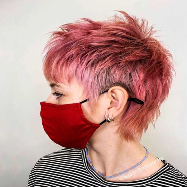 Shaggy Feathered Texture Pixie Hair - A woman wearing a red mask