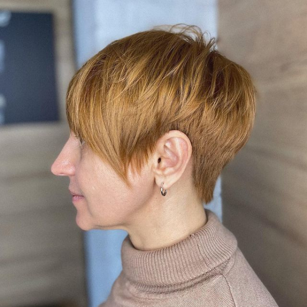 Short Layered Pixie Hairstyle - A woman wearing a turtle neck top