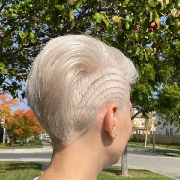Side Undercut Pixie Cut - A woman with a nature background