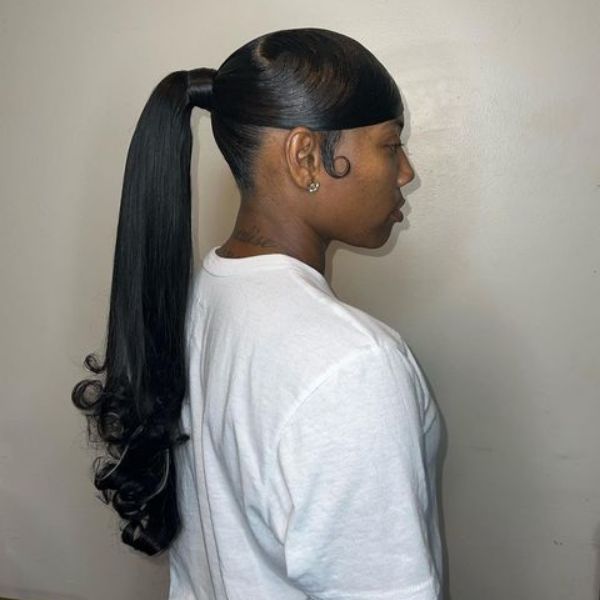 A woman standing with her sleek knot hairstyle
