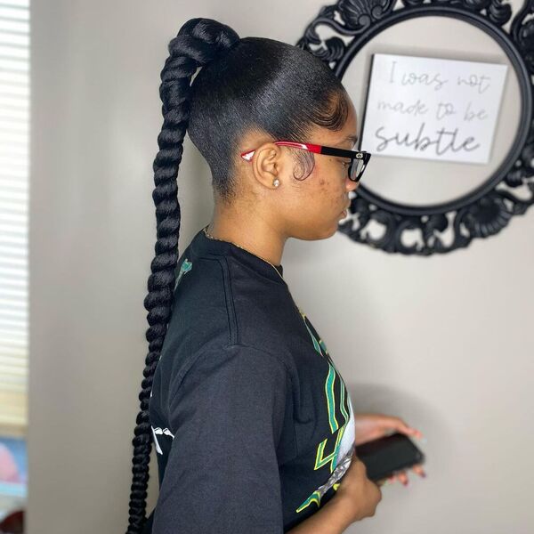 Sleek Ponytail with Braiding Hair - A woman with eyeglasses wearing a black printed shirt