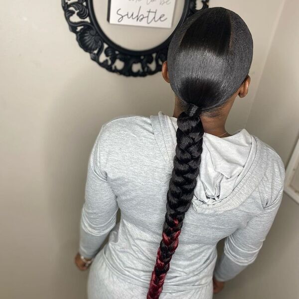 Sleek Triangle Part Braid Ponytail - A woman wearing a gray hooded jacket