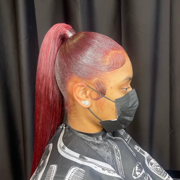 Spicy Dark Red Swoop Pony Style - A woman wearing a black mask