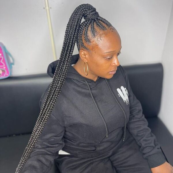 Stitch Knotless Ponytail Braid - A woman wearing a black hooded jacket
