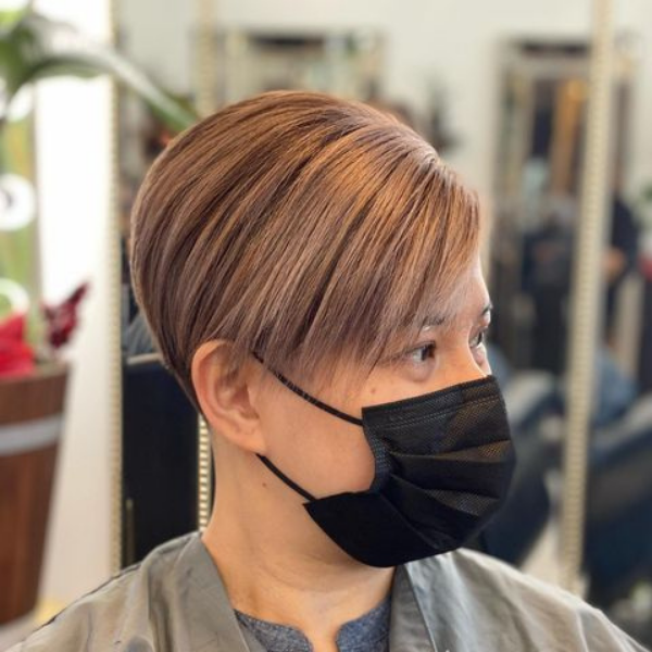Straight Pixie Hair - A woman wearing a black mask