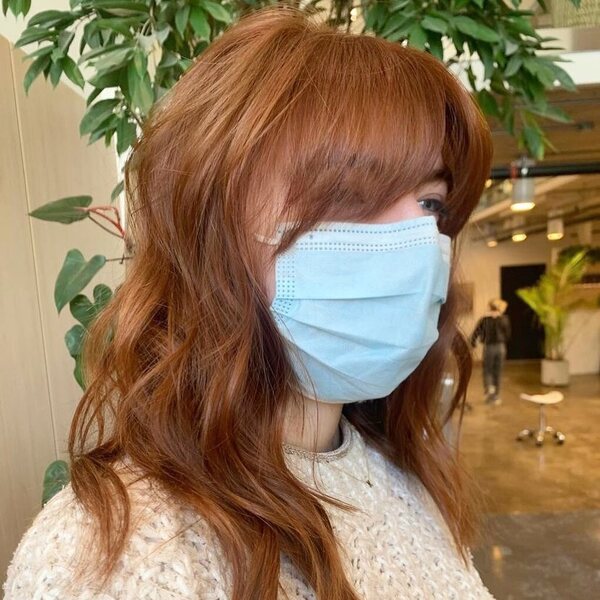 Stunning Cinnamon Auburn Hair for Medium Length Hair - a woman wearing a facemask