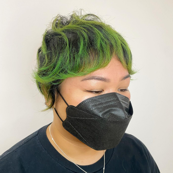 Thin Shaggy Pixie Hair for Chubby Face - A woman wearing a black mask