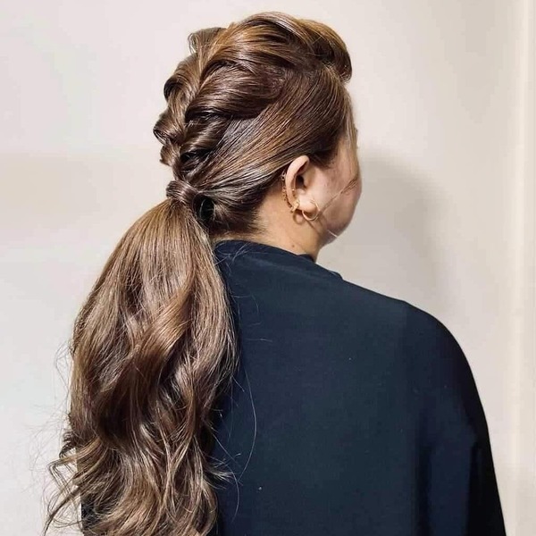 Twisted Low Ponytail - A woman wearing a black sweater jacket