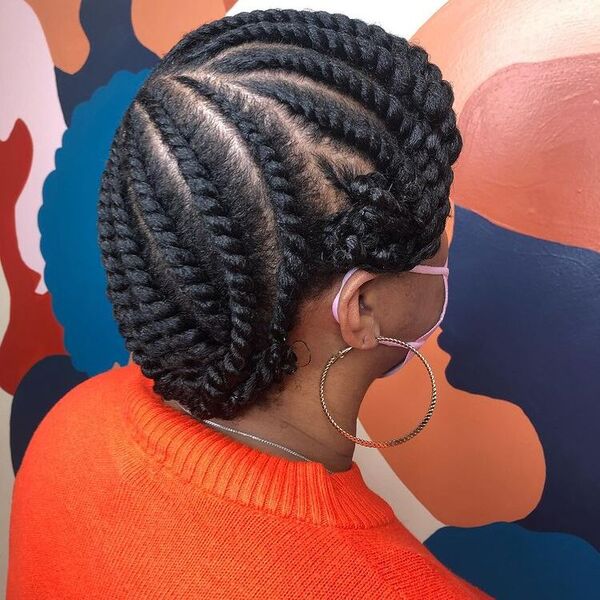 Two Strand Updo Twist - A woman wearing a knitted orange sweater