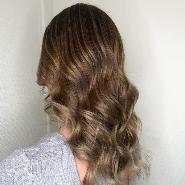 Wavy Light Brown with Ashy Edge - A woman wearing a light grey top