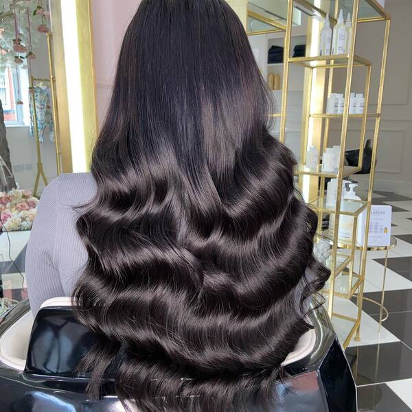 Weave Fitted Over 3 Rows and Curled - A woman inside a salon