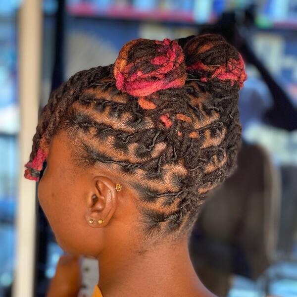 Yarn Style Dread with Two High Buns - A woman wearing earrings