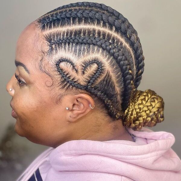 5 Straight Back African Cornrow Braid Hairstyles with Heart Design - A woman wearing a pink hooded jacket