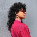 50 Cool Curly Hair Mullet for Woman in 2022 - a woman wearing a sunglasses