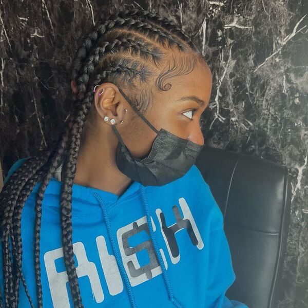 8 Feed-in Stitch Cornrow Braids - A woman with black facemask wearing a blue printed hooded jacket