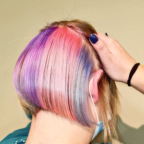 Angled Bob with Rainbow Hair Colors  - A woman wearing a surgical facemask