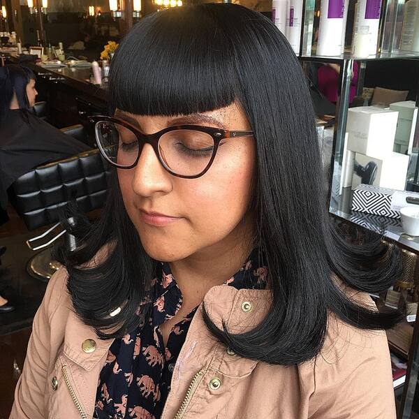 Bang Trim and Smooth Blowout - a woman wearing an eyeglasses