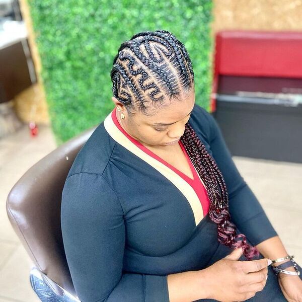 Beautiful All Back Cornrow Braids with Design - A woman wearing a black wholedress